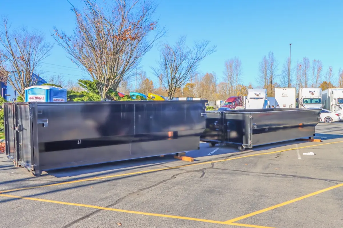 Professional dumpster rental service with roll-off container on residential driveway in Bonita Springs